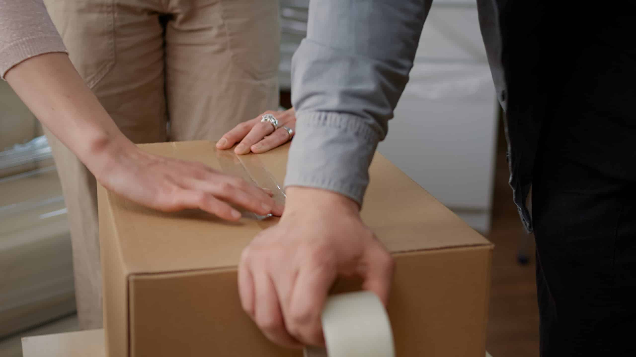 couple preparing boxes for downsizing