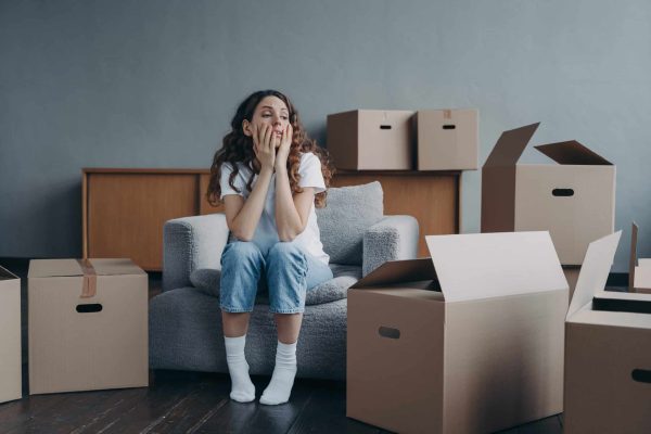 DIY move woman stressed out surrounded by boxes