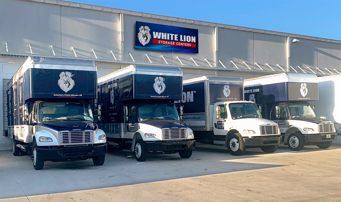 fleet of white lion trucks outside white lion warehouse