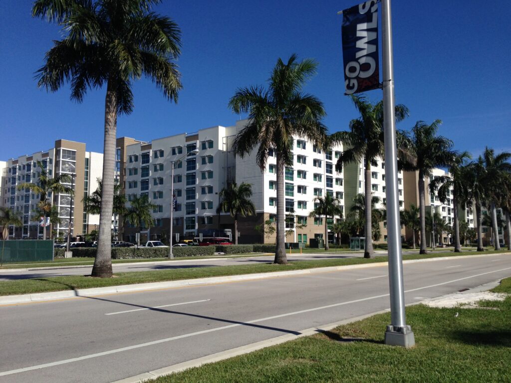 FAU Innovation Village across four lanes of traffic with a sign in front that reads "Go Owls"